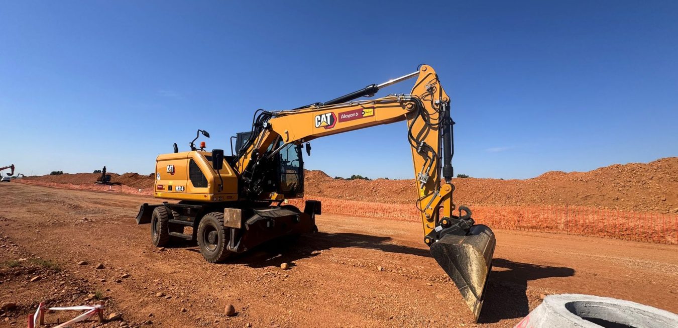 Caterpillar CAT M314 wheeled excavator rented from Alayan Rentals positioned on a road excavation and earthmoving site Alayan Alquileres