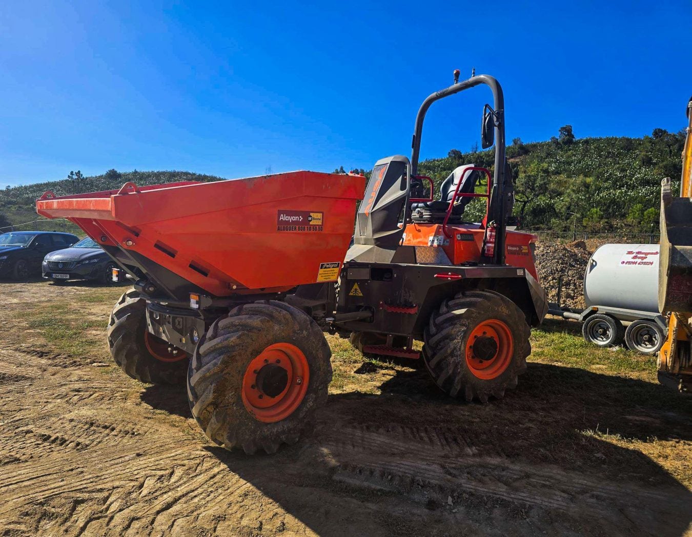 Orange Ausa D350AHG wheeled dumper with swivel skip and ROPS protection bar available for rental from Alayan Rentals Alayan Rent