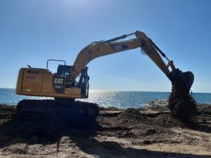 Heavy yellow Caterpillar CAT 318F L tracked excavator with triple-articulated boom operating on jobsite for earthmoving for rent – Alayan Rentals