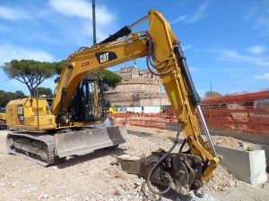 Heavy yellow Caterpillar CAT 313F L tracked excavator on jobsite with hydraulic boom and dozer blade for rent – Alayan Rentals