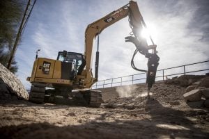 CAT B8 hydraulic breaker attachment mounted on Caterpillar 309 CR mini excavator breaking ground for rent – Alayan Rentals