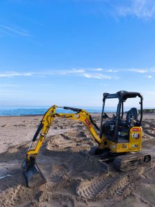 Yellow Caterpillar CAT 301.7 tracked mini excavator operating on sand for rent – Alayan Rentals