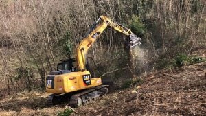 Hydraulic forestry mulcher head mounted on a Caterpillar CAT 313F L GC tracked excavator clearing land for rent – Alayan Rentals