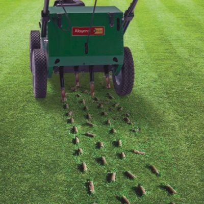 Rental engine-powered aerator by Alayan Rentals in action for lawn coring and aeration using hollow tines.