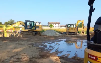 Two Caterpillar CAT crawler excavators for rent from Alayan Rentals at work on a construction site for digging and earthmoving