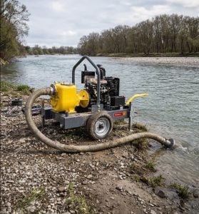 Mobile self-priming centrifugal pump for rent from Alayan Rentals positioned on a riverbank for water intake