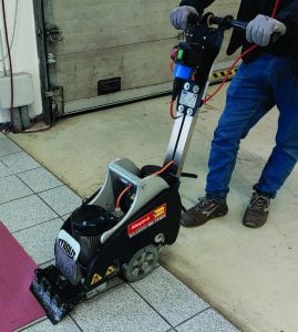 Operator at work with a Tyrolit floor stripper machine for rent by Alayan Rentals on interior flooring