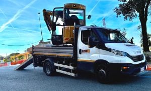 Iveco Daily truck with loading ramps for rent from Alayan Rentals used to transport a Caterpillar mini excavator